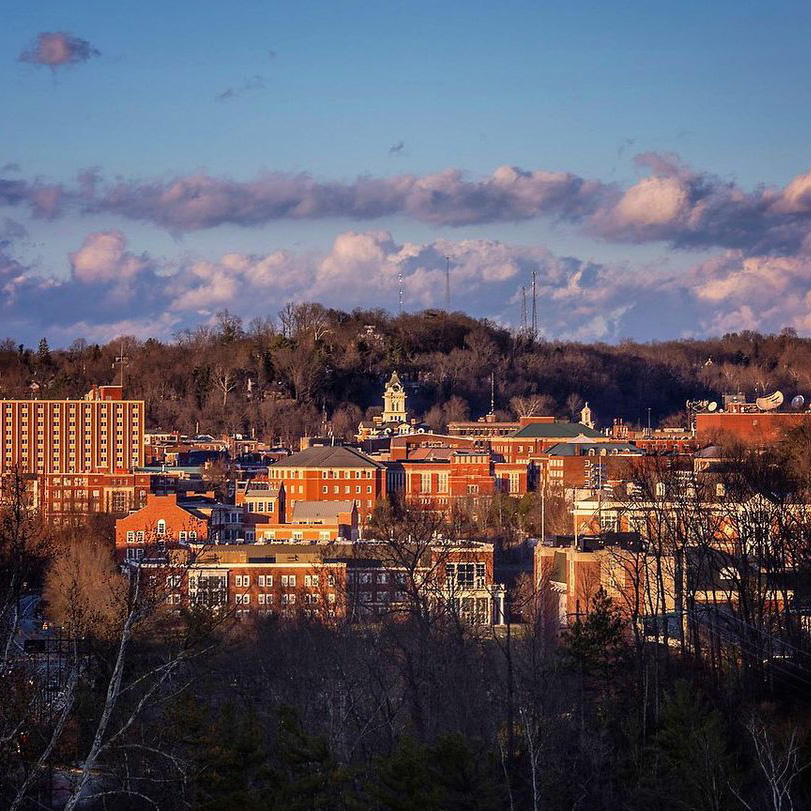 ohio university campus with sunshine, blue sky, and clouds