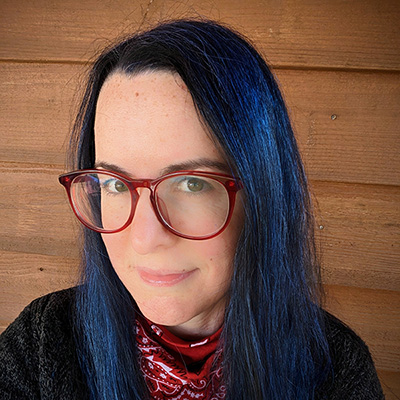 picture of Cassie Lewis wearing red and blue and looking at the camera